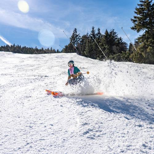 A person skiing in spring at Sunday River.