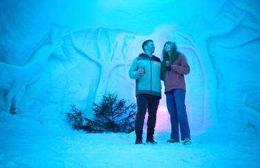 A couple looking at colorful lights and ice sculptures at Sunday River.