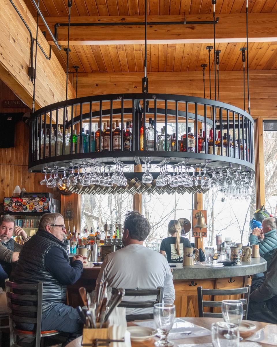 People sitting at the bar at the Mountain Room at Sunday River.