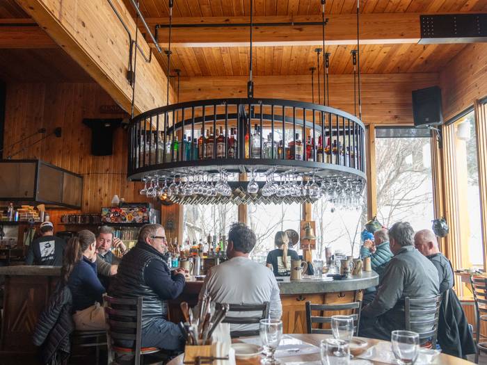 People sitting at the bar at the Mountain Room at Sunday River.