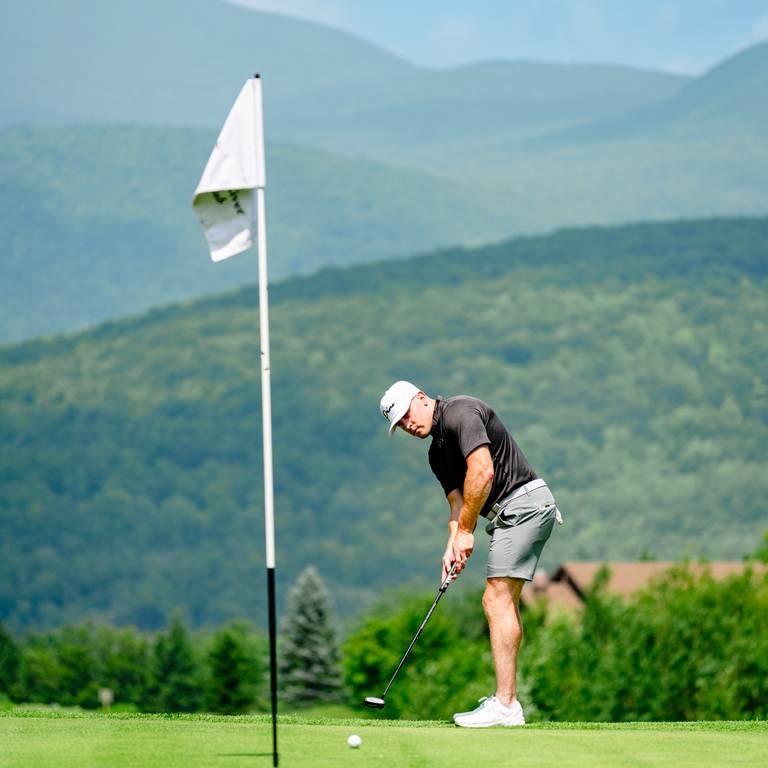 A person putting at Sunday River Golf Club.