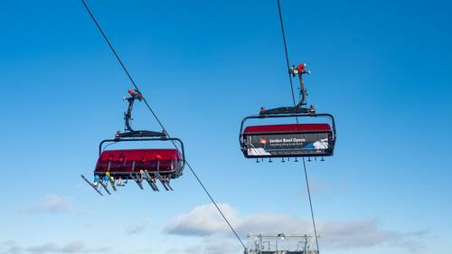 Skiers in the Jordan 8 chairlift.