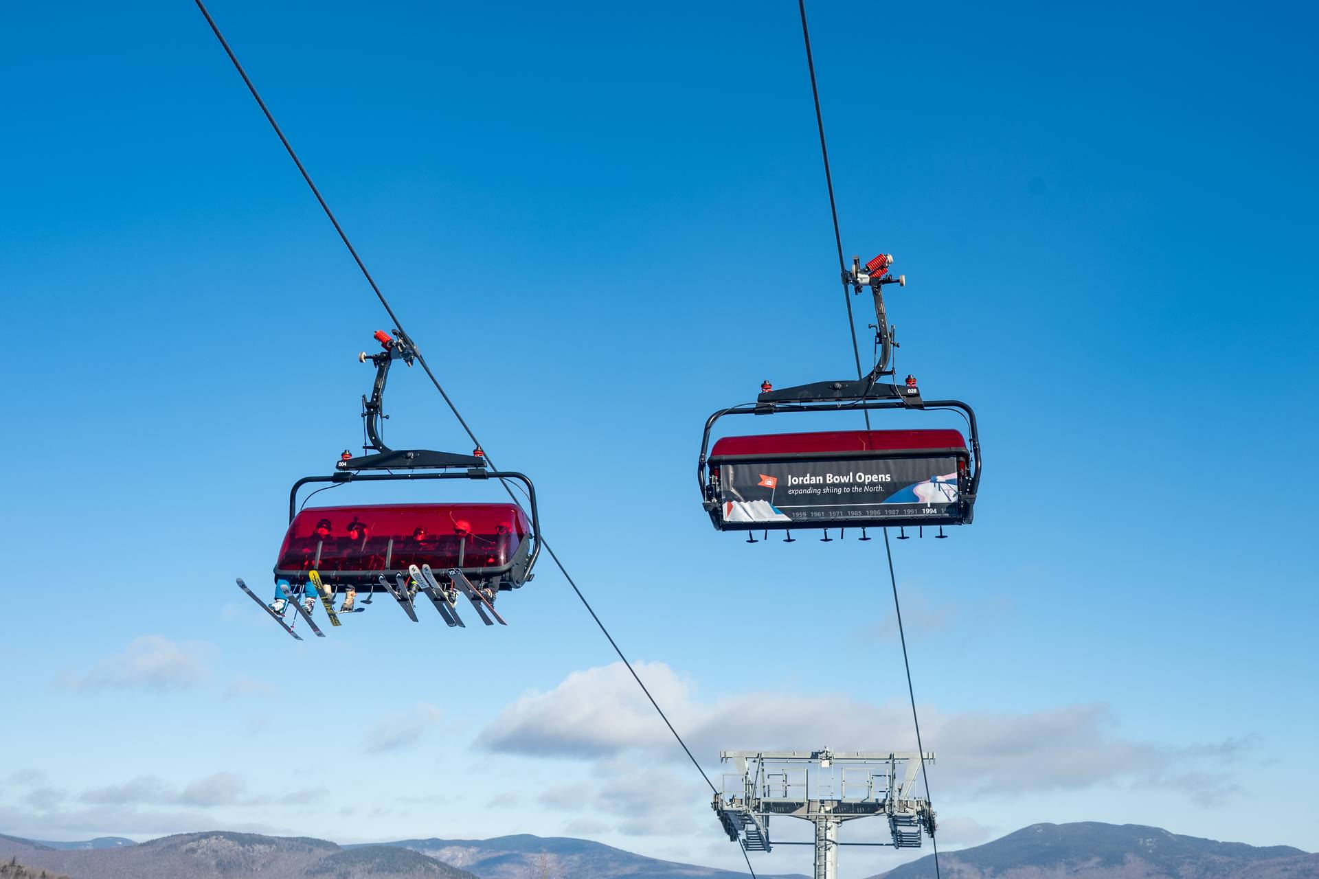 Skiers in the Jordan 8 chairlift.