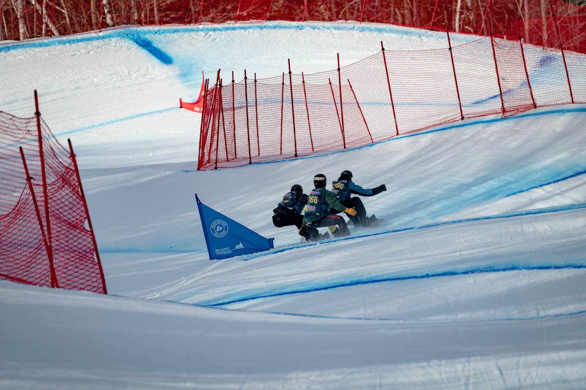 Snowboarders going through a course during a competition at Sunday River.