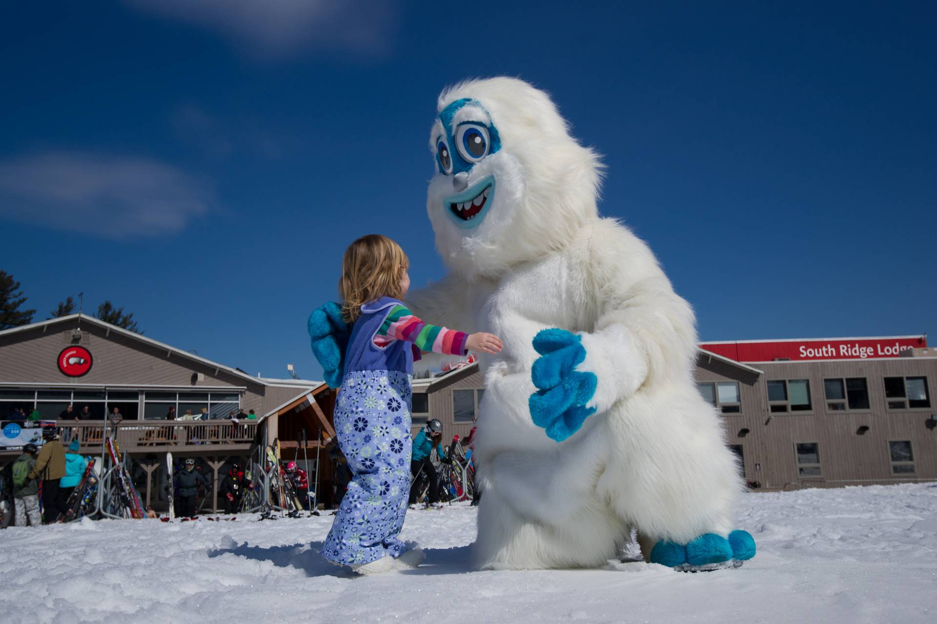 A small child running up the Eddy the Yeti at Sunday River.