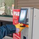A person scanning their phone at a PUB machine to print their go card at Sunday River.
