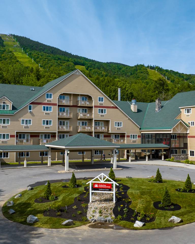 The entrance to the Grand Summit Hotel in the summer at Sunday River Resort.