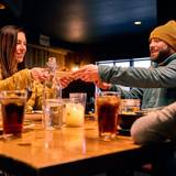 Camp dining room at Sunday River with people sharing food.