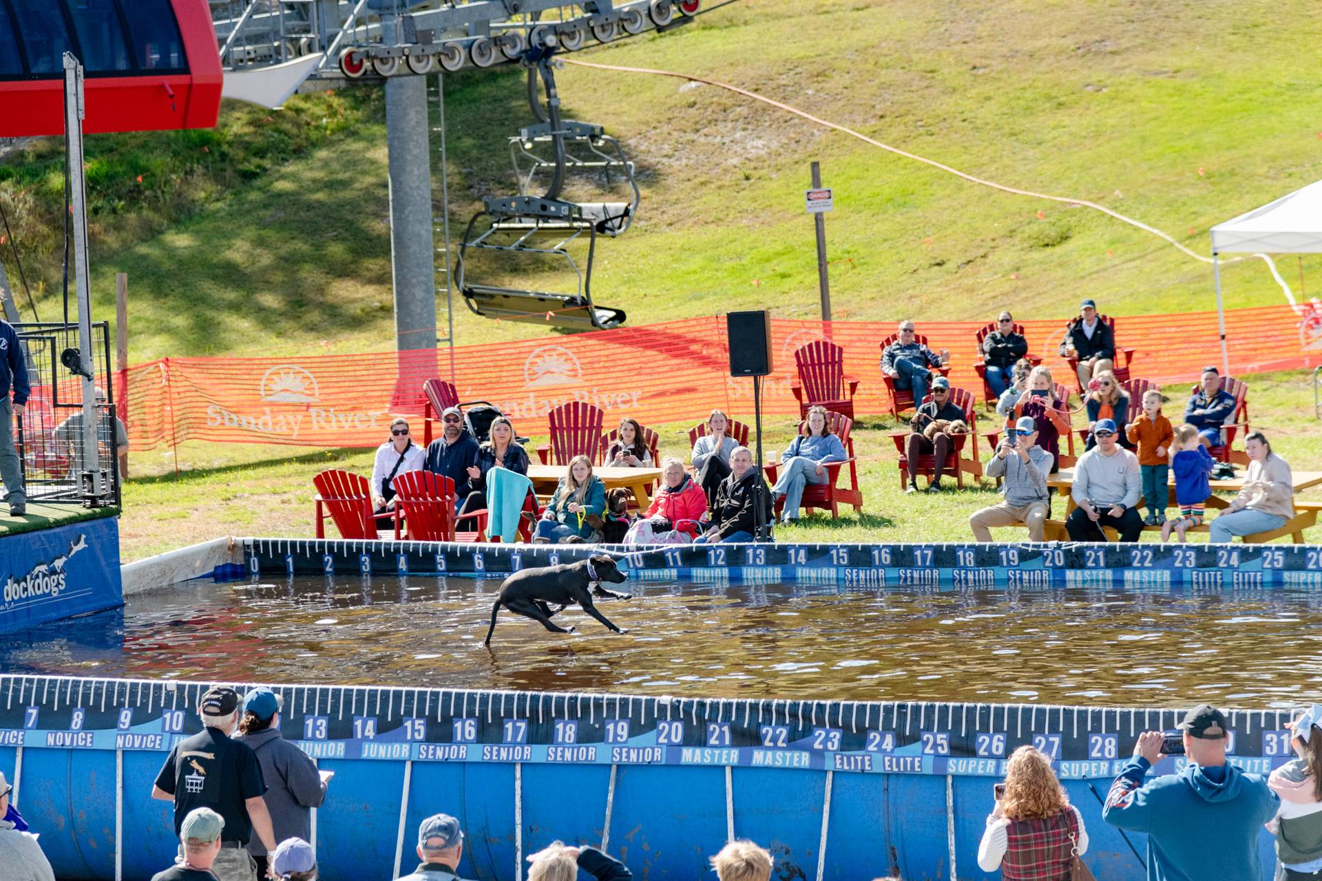 Spectators watching dogs jump into the Dock Dogs pool at Sunday River.