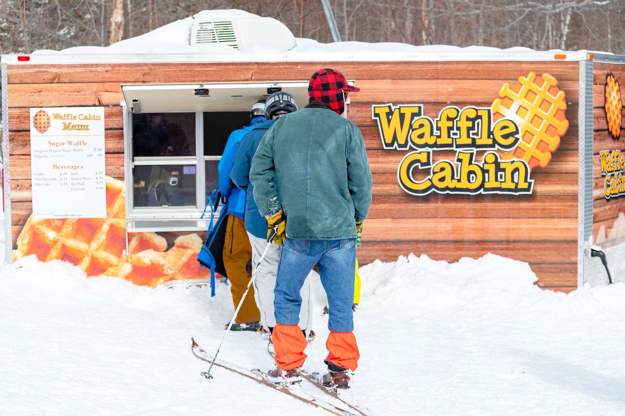 People standing in line to grab a waffle from the Waffle Cabin at Sunday River.