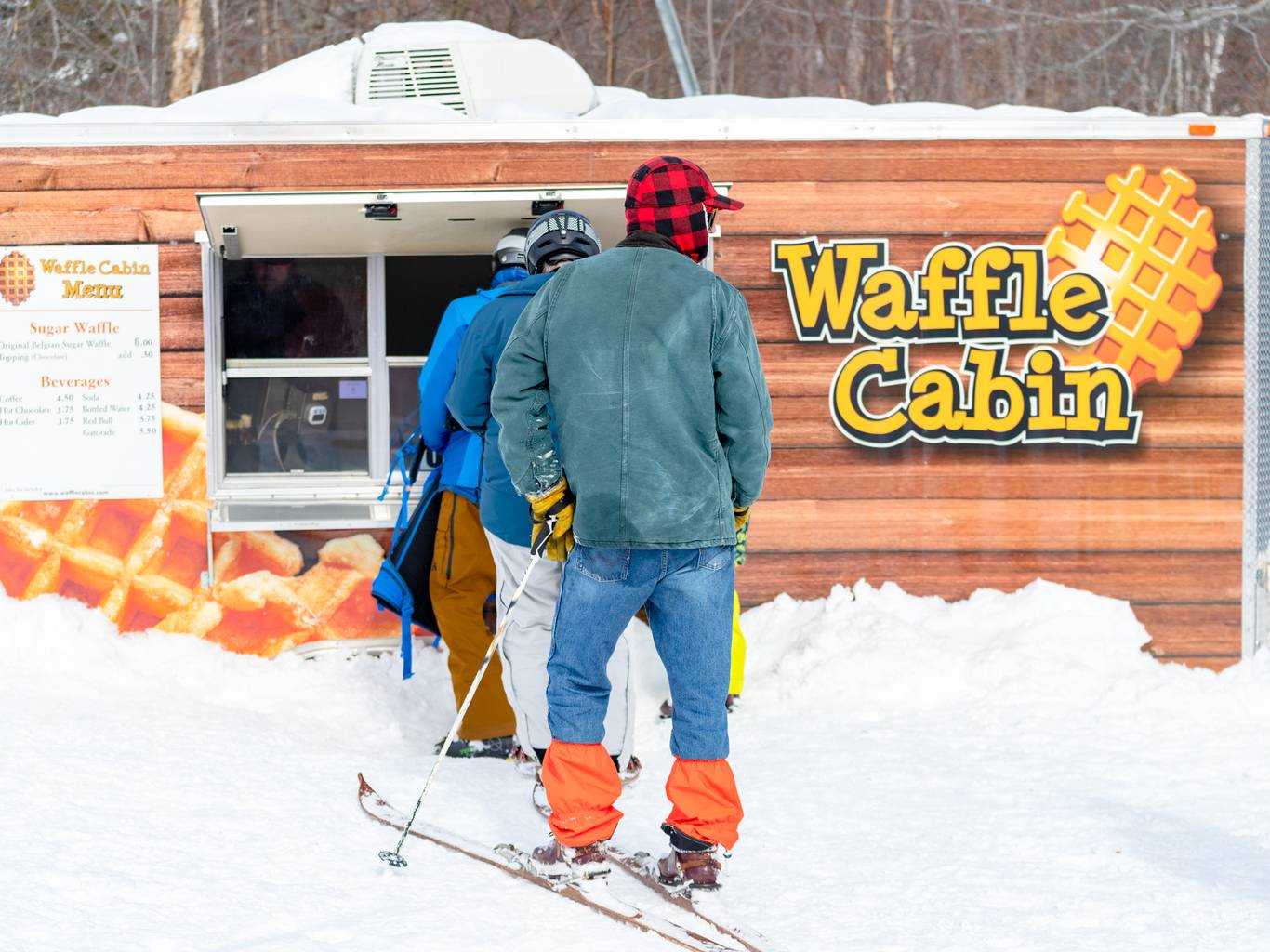 People standing in line to grab a waffle from the Waffle Cabin at Sunday River.