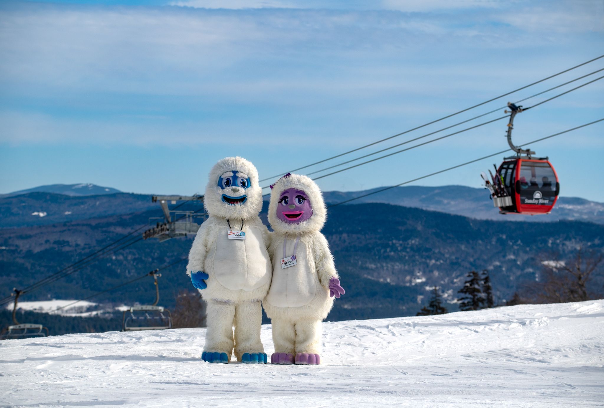 A little girl getting a hug from Betty the Yeti at Sunday River.