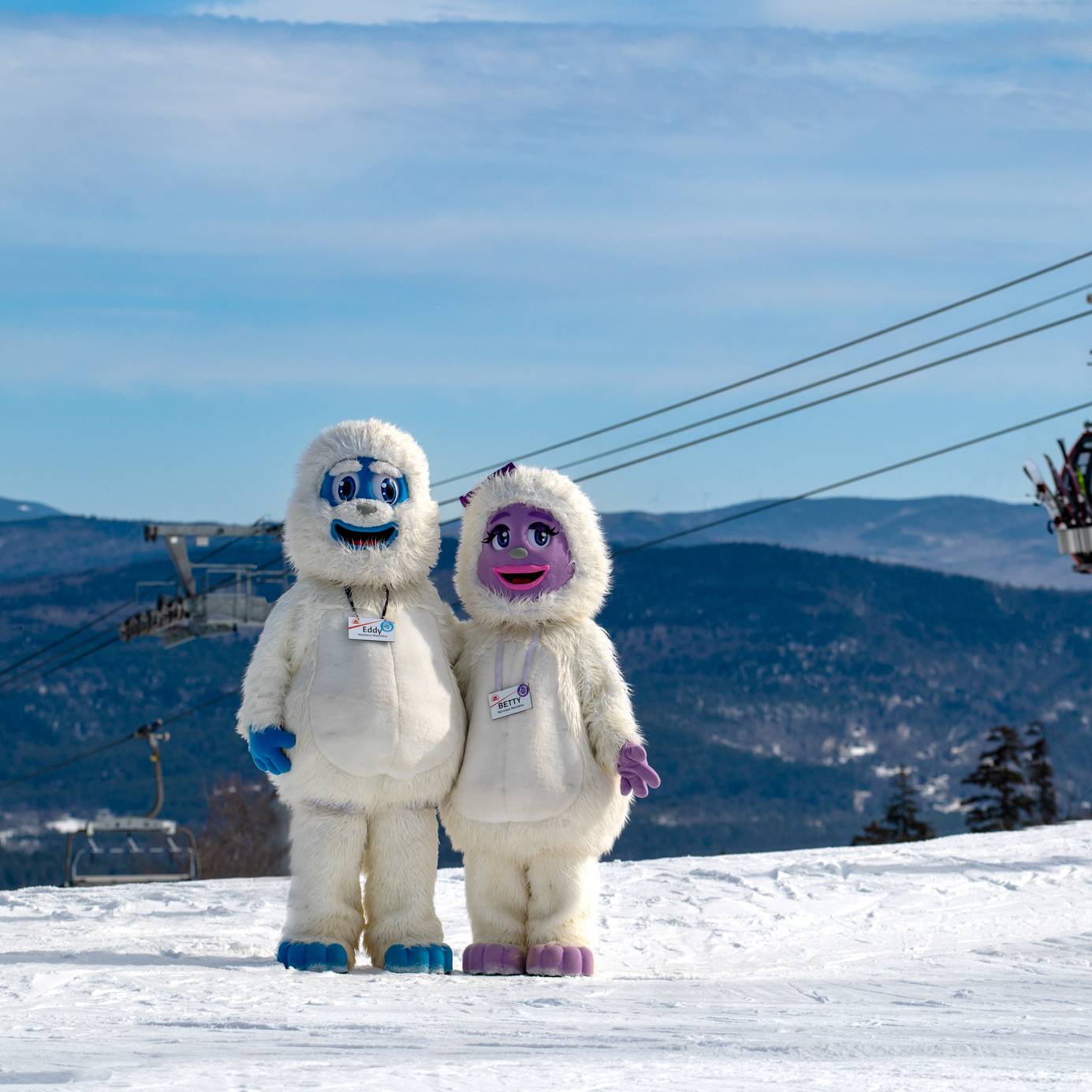 A little girl getting a hug from Betty the Yeti at Sunday River.