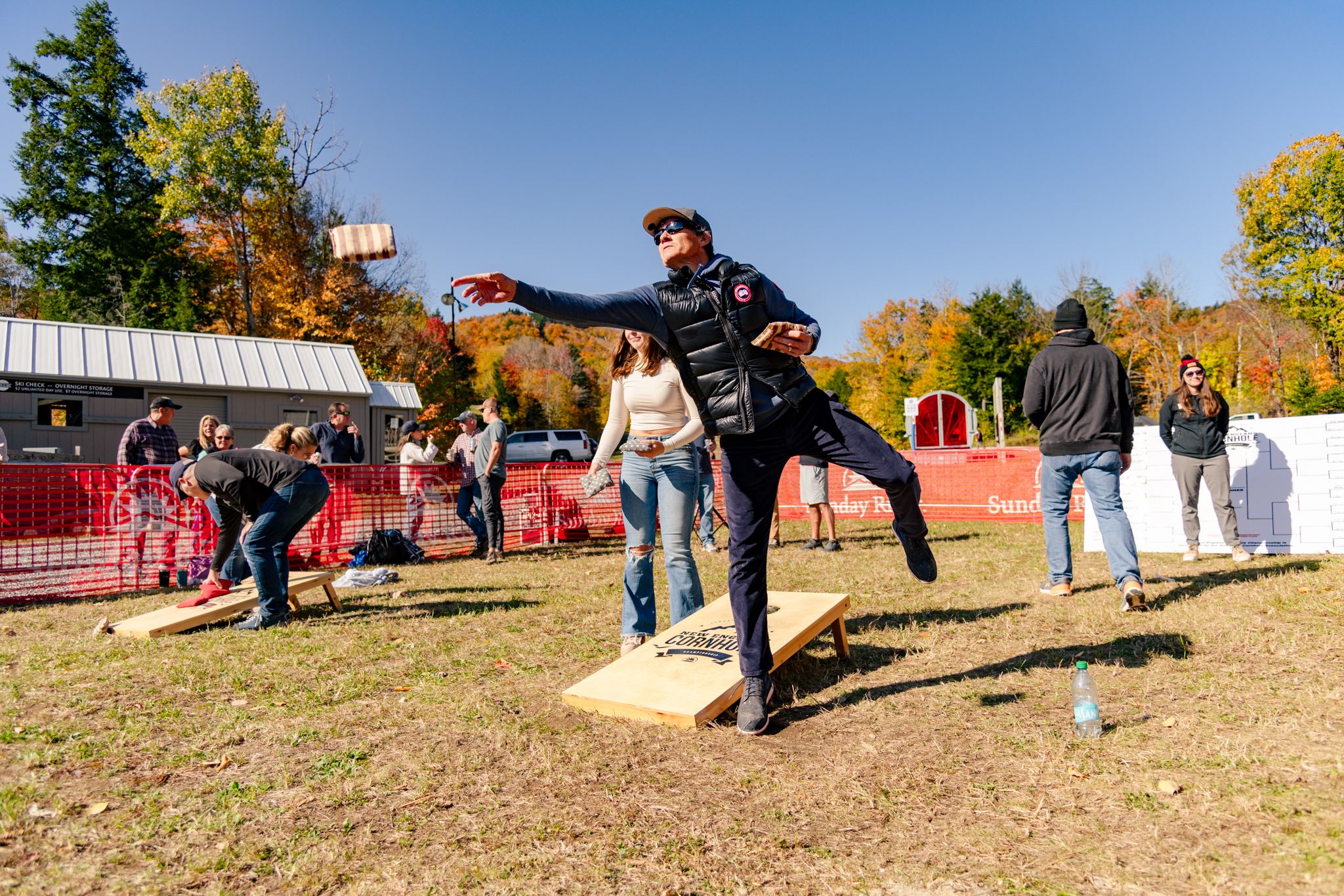 A person tossing a bean bag during a game.