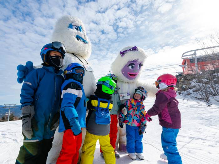 Kids posing for a picture with Eddy and Betty.