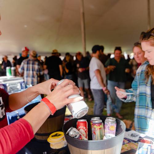 A brewer pouring a drink for a guest at the Maine Brew Fest at Sunday River.