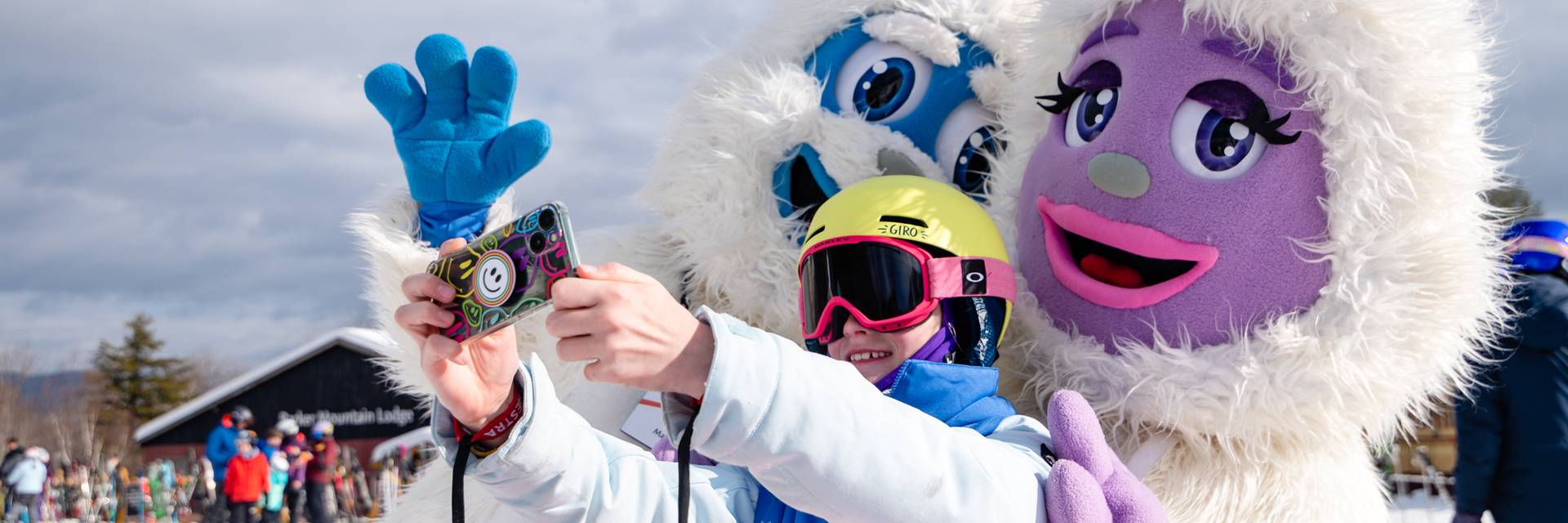 Kid posing with Eddy and Betty the Yetis