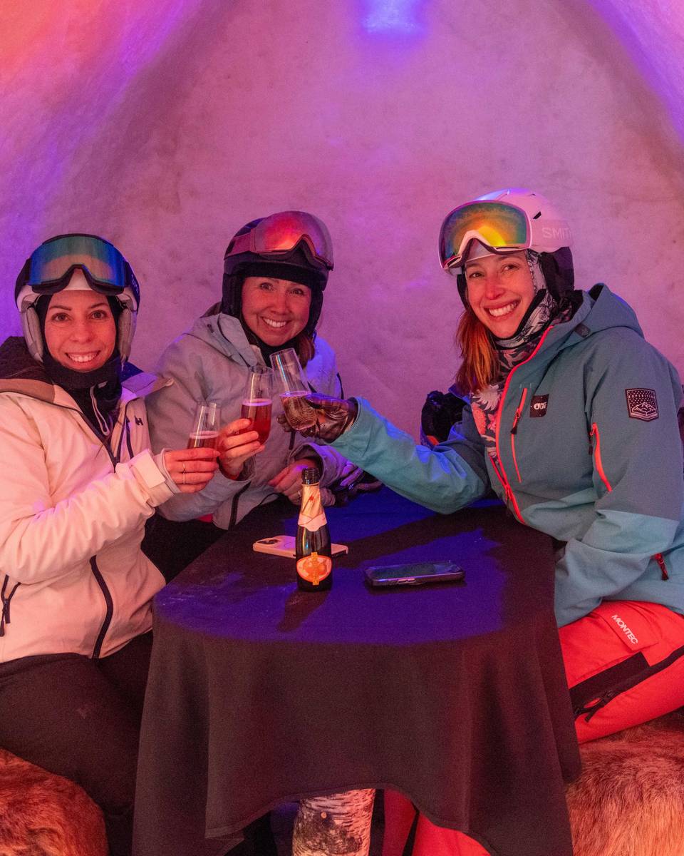 A group of friends sitting in an ice pod at The Iglu at Sunday River.