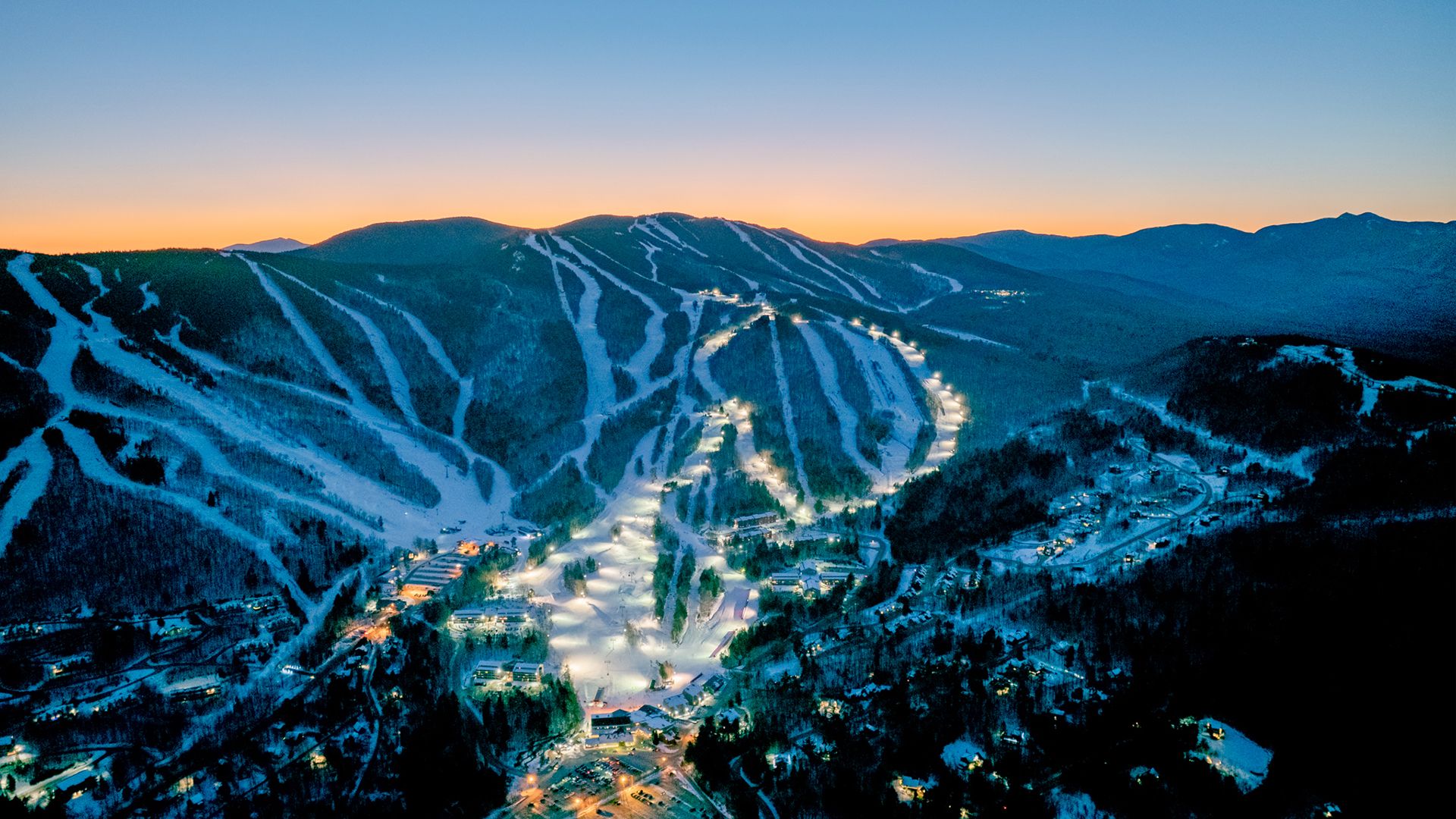 Twilight skiing trails with lights at Sunday River in the evening.