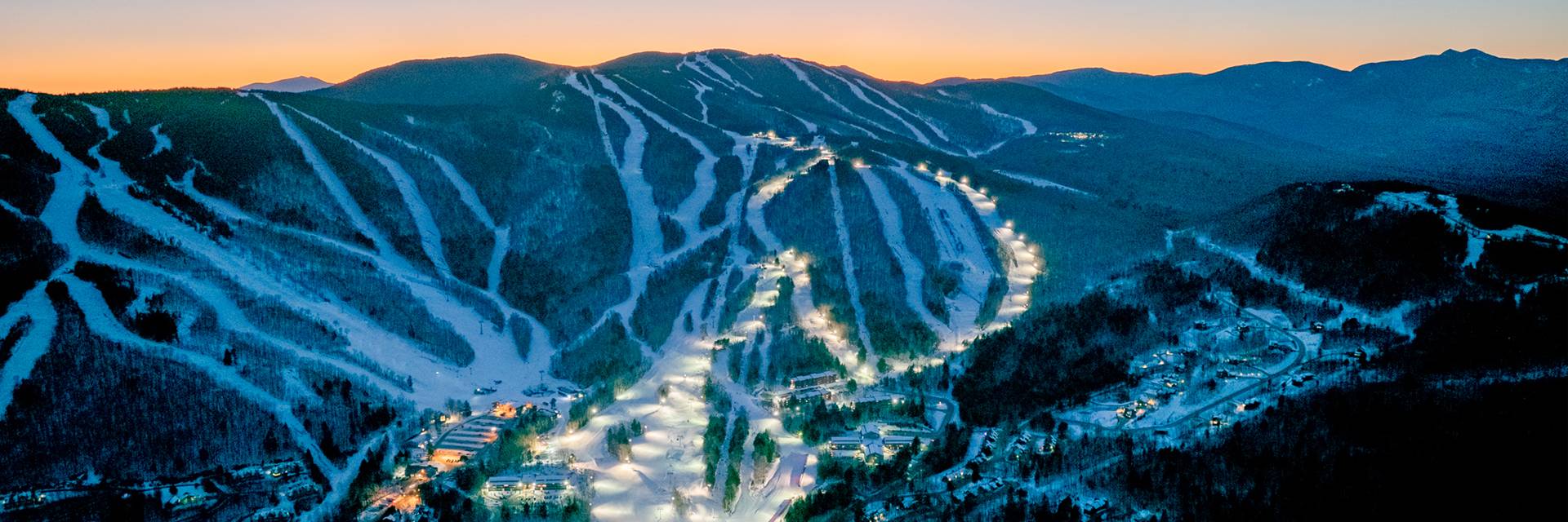 Twilight skiing trails with lights at Sunday River in the evening.