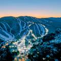 Twilight skiing trails with lights at Sunday River in the evening.