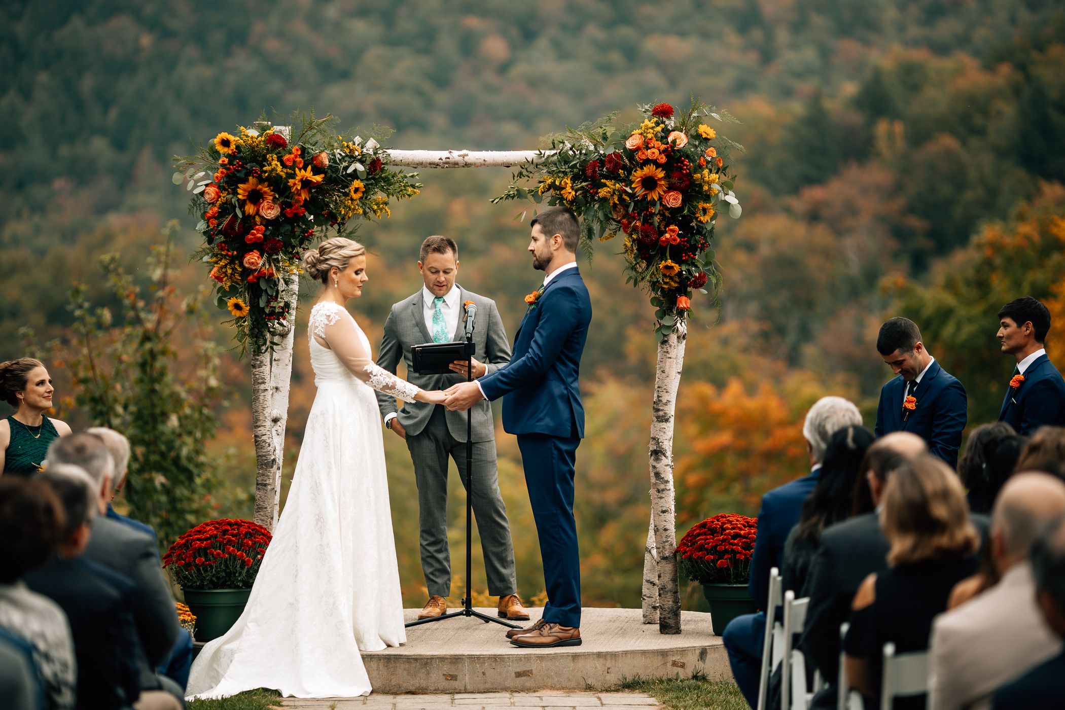 A husband and wife saying "I Do" in the fall.