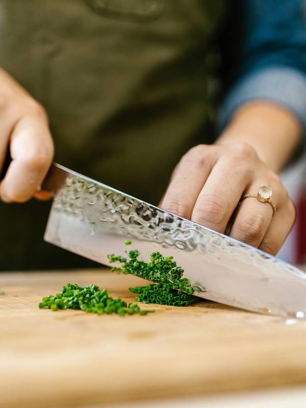 A chef cutting cilantro at the Chef Summit at Sunday River.