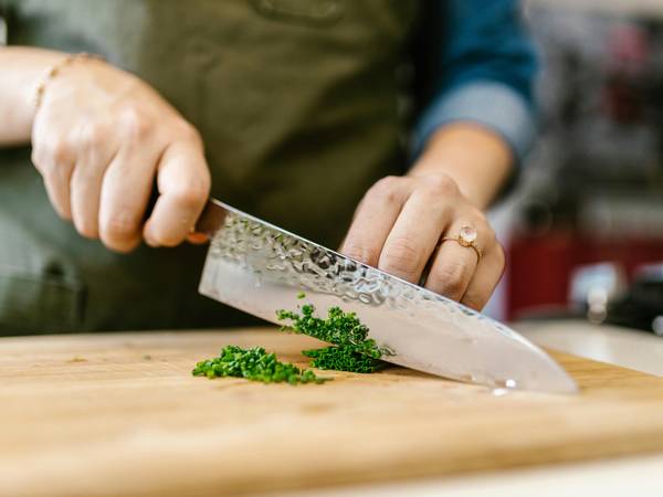 A chef cutting cilantro at the Chef Summit at Sunday River.
