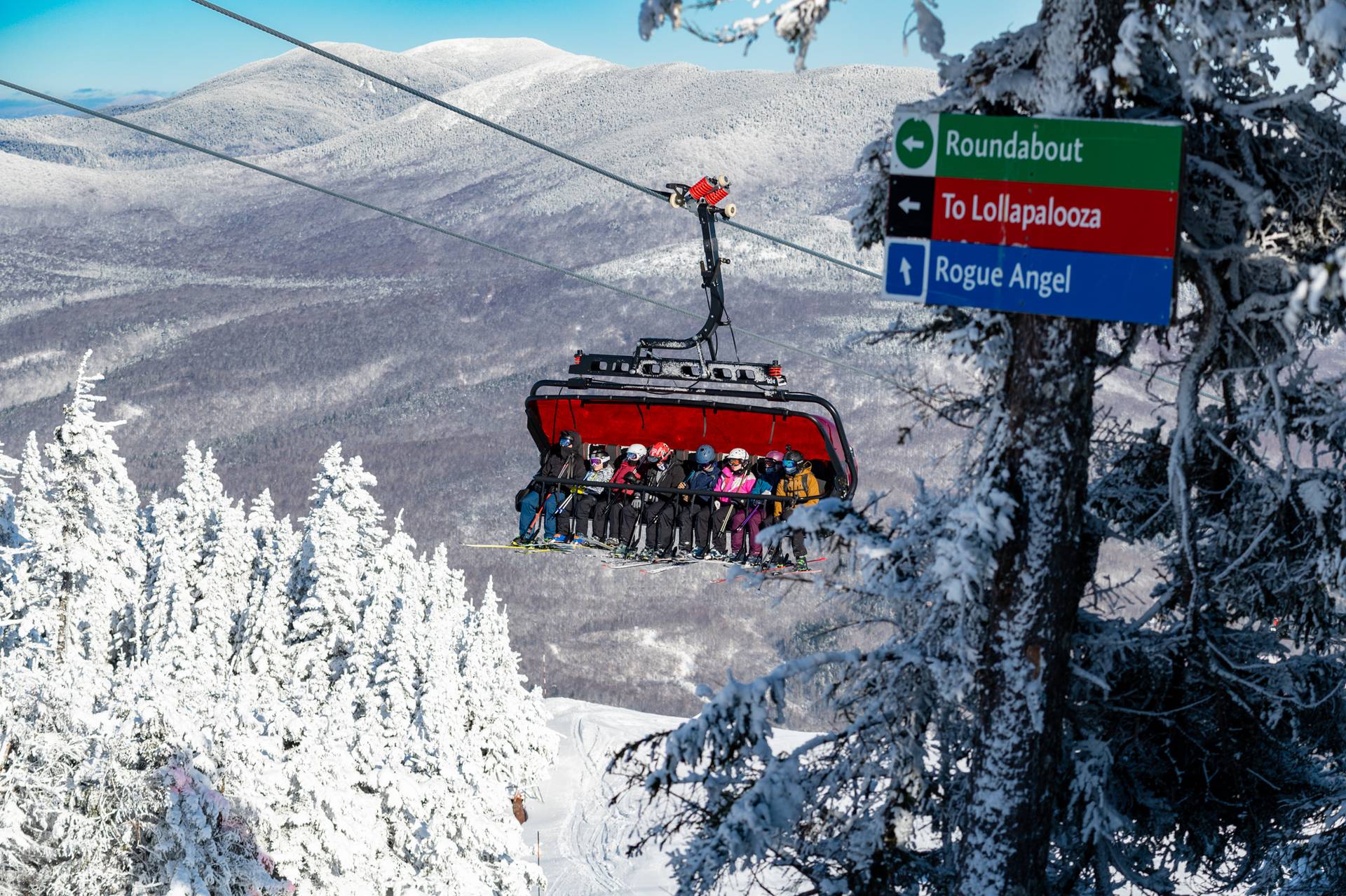 A group of skiers riding up the Jordan 8 chairlift at Sunday River.