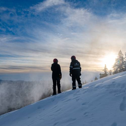 Snowmakers talking while making snow at Sunday River.