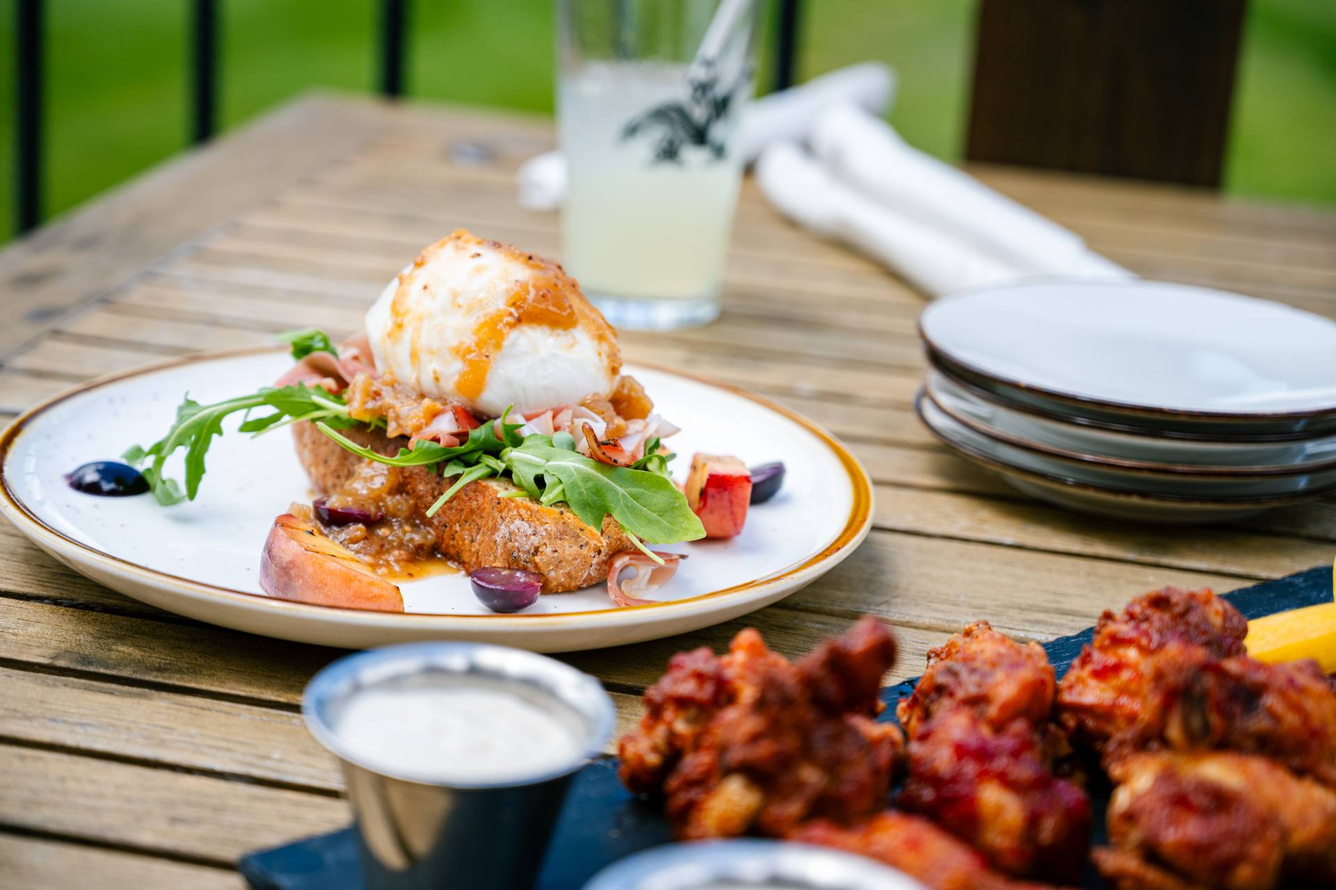 Plates of food at the Sunday River Golf Club, including wings and cheese.