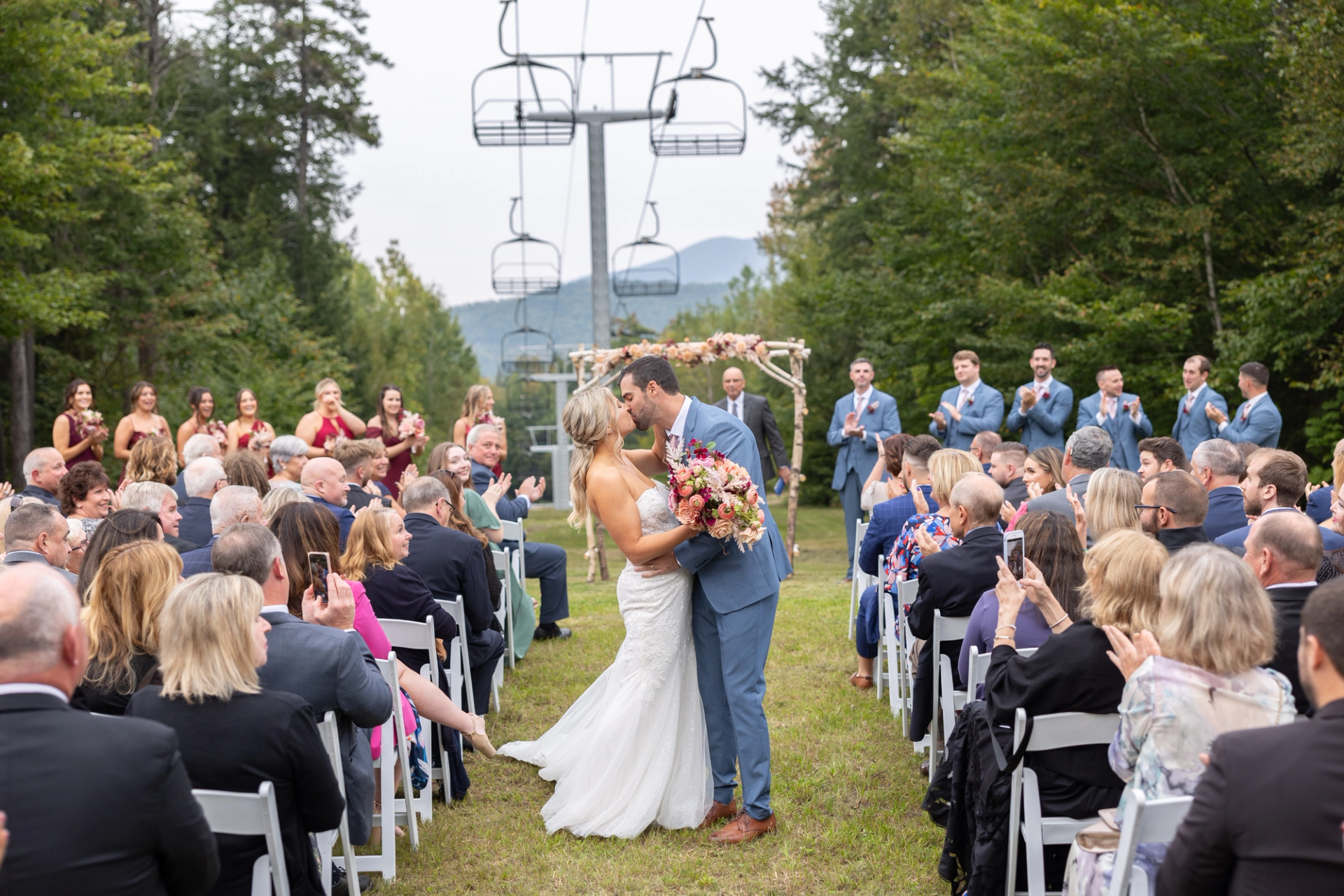 A couple share their first kiss after their wedding.