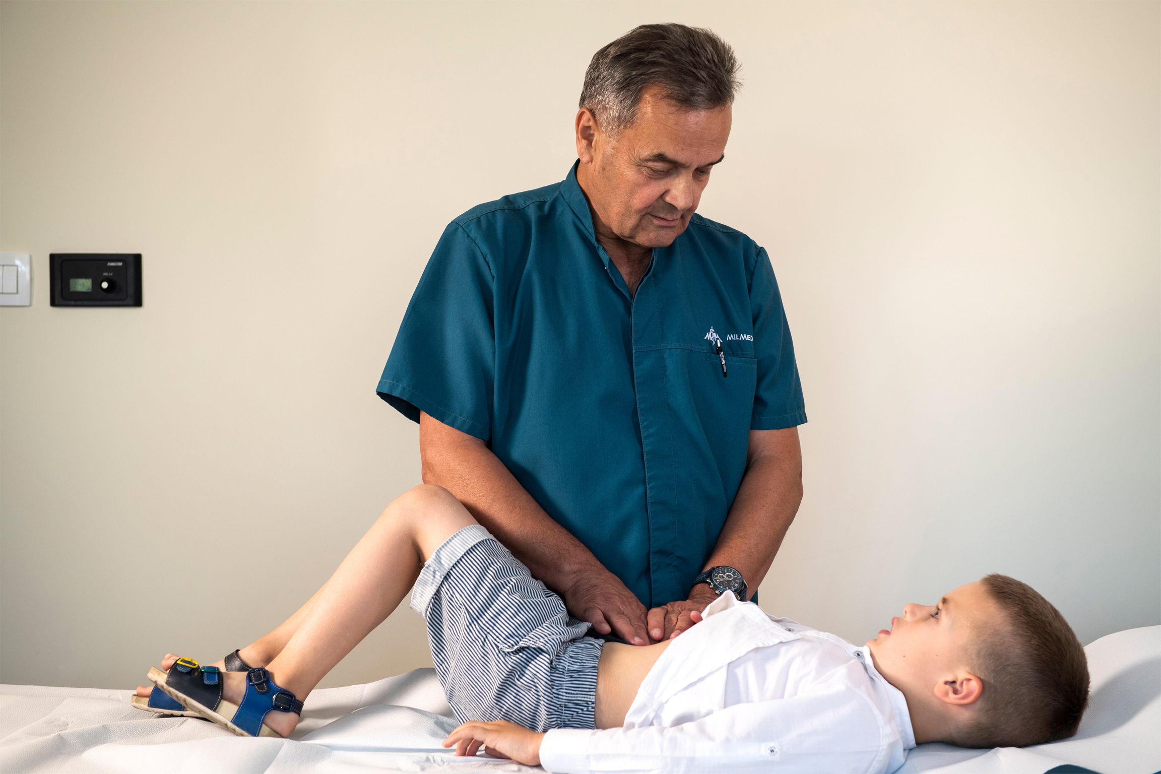 Dr. Albijanić examining a boy's lower abdomen