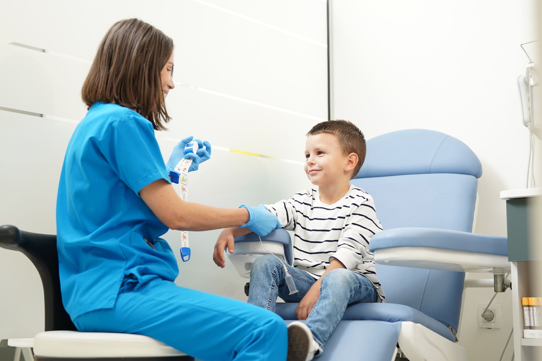 A nurse takes a blood sample from a boy