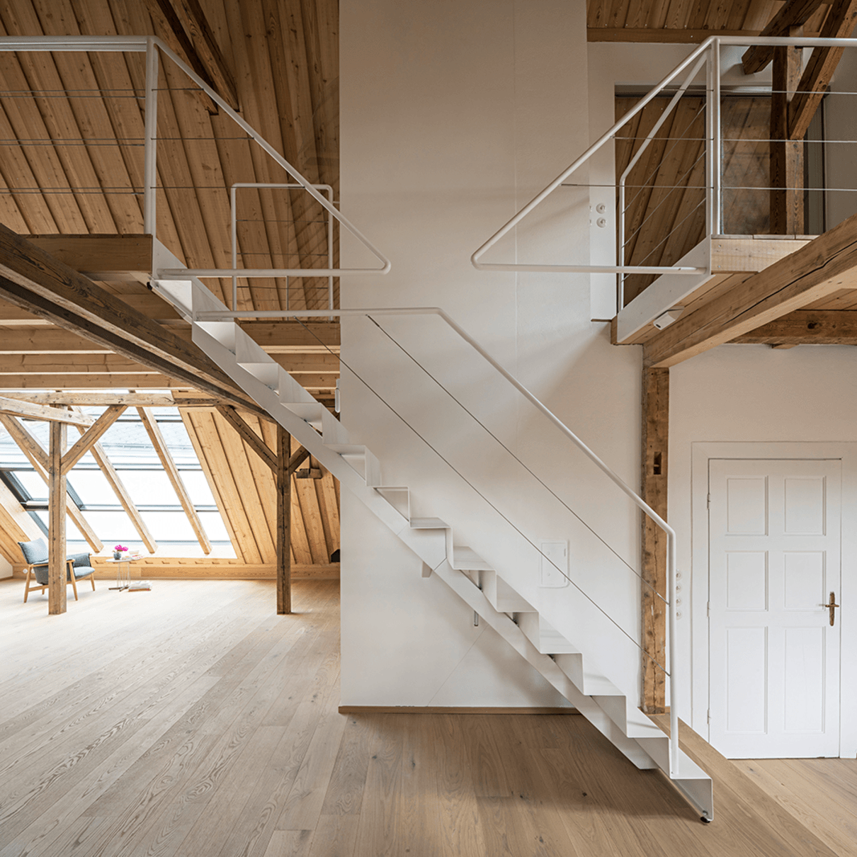 Kippende weiße Treppe, Galerie, Holzboden, Holzdecke, weiße Wand