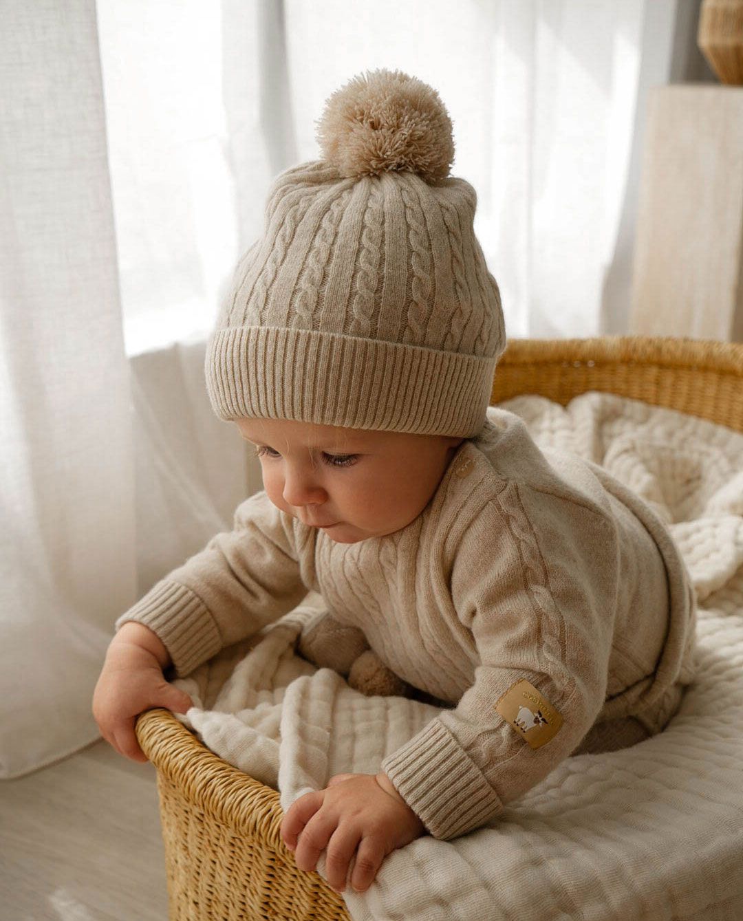 Baby wearing cashmere jumper and beanie