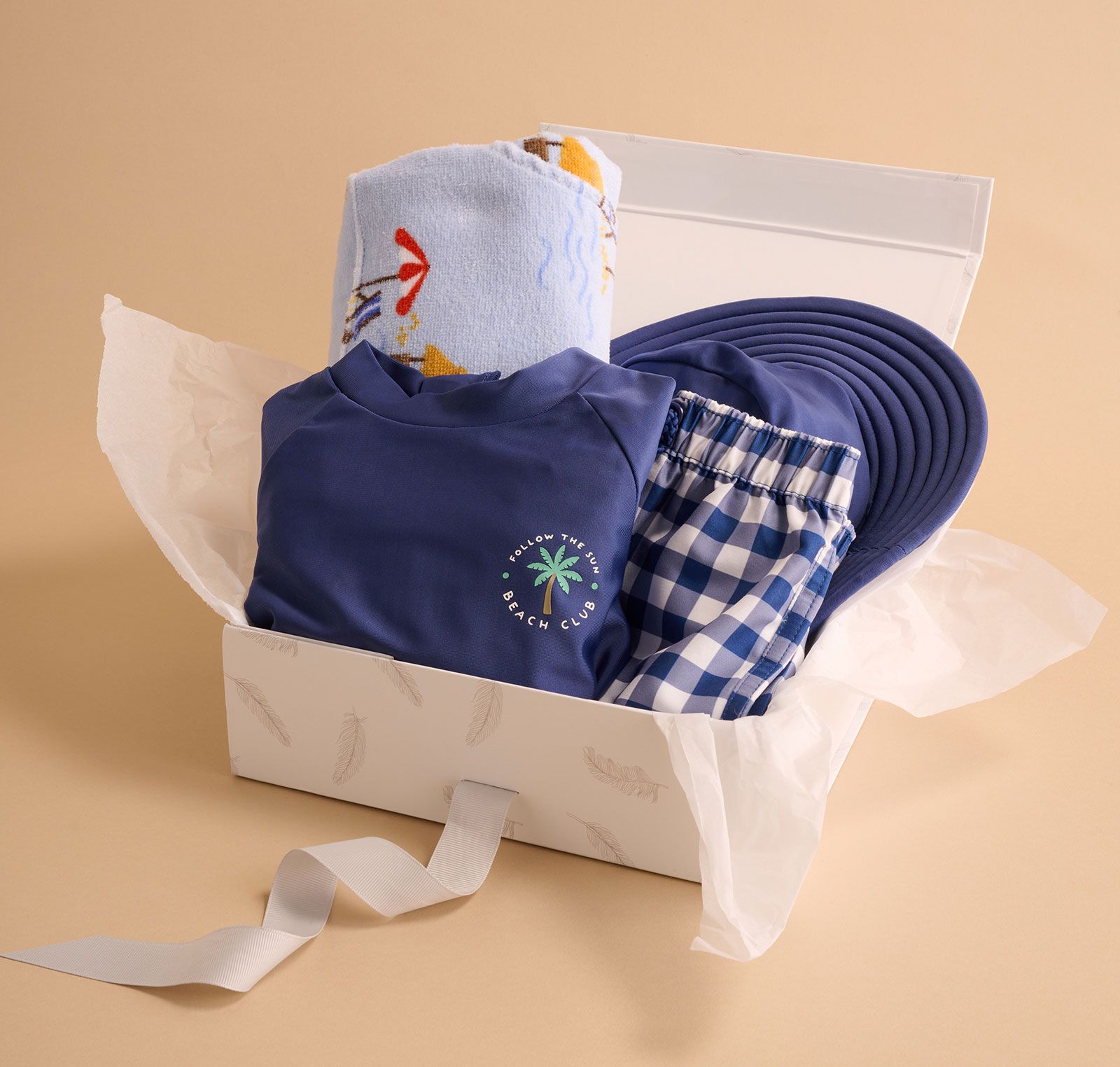 Gift box containing Purebaby blue swimwear and hooded towel