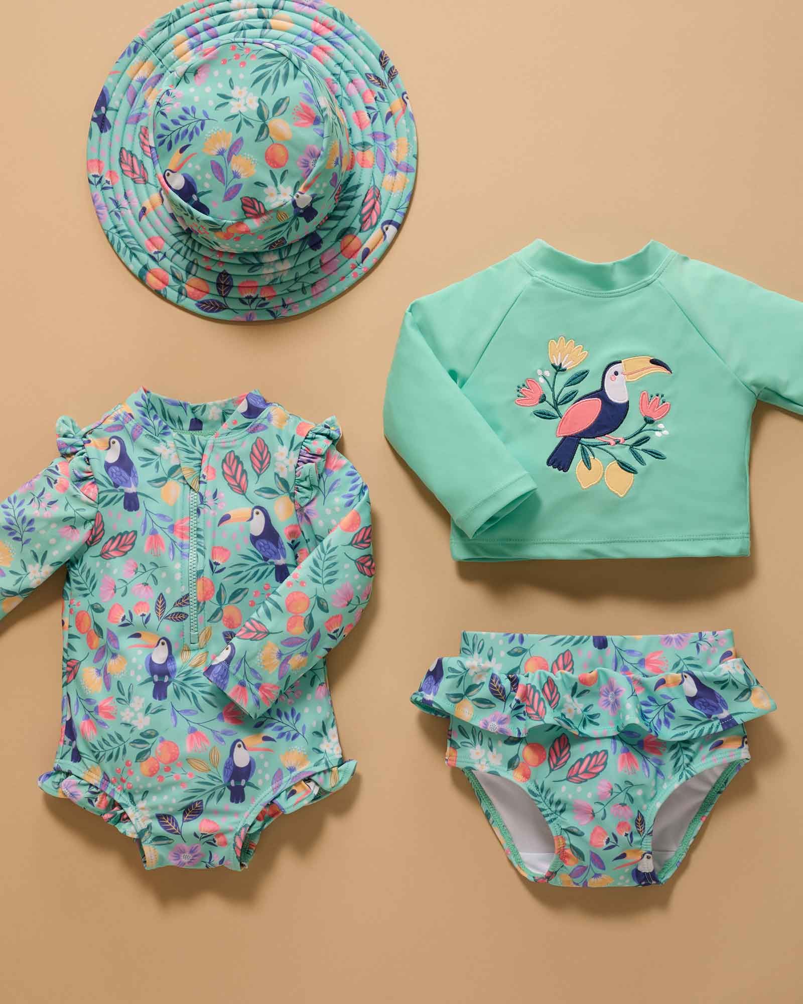 Swim styles and hat layed out on coloured paper