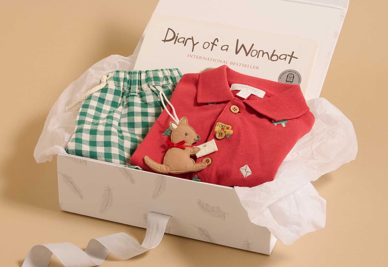 Gift box containing Purebaby toddler styles for Christmas