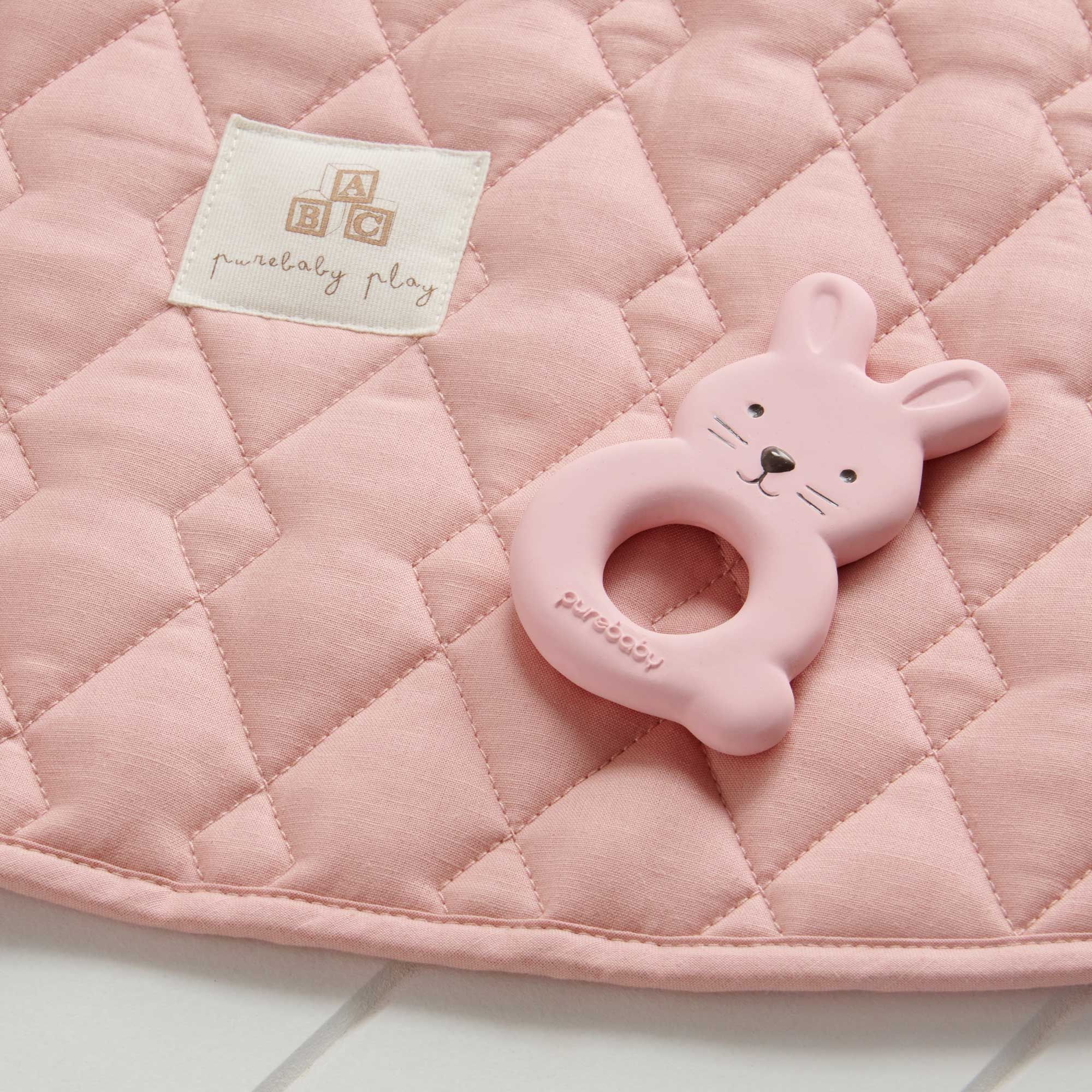 Flat lay of Purebaby’s bunny natural rubber teether