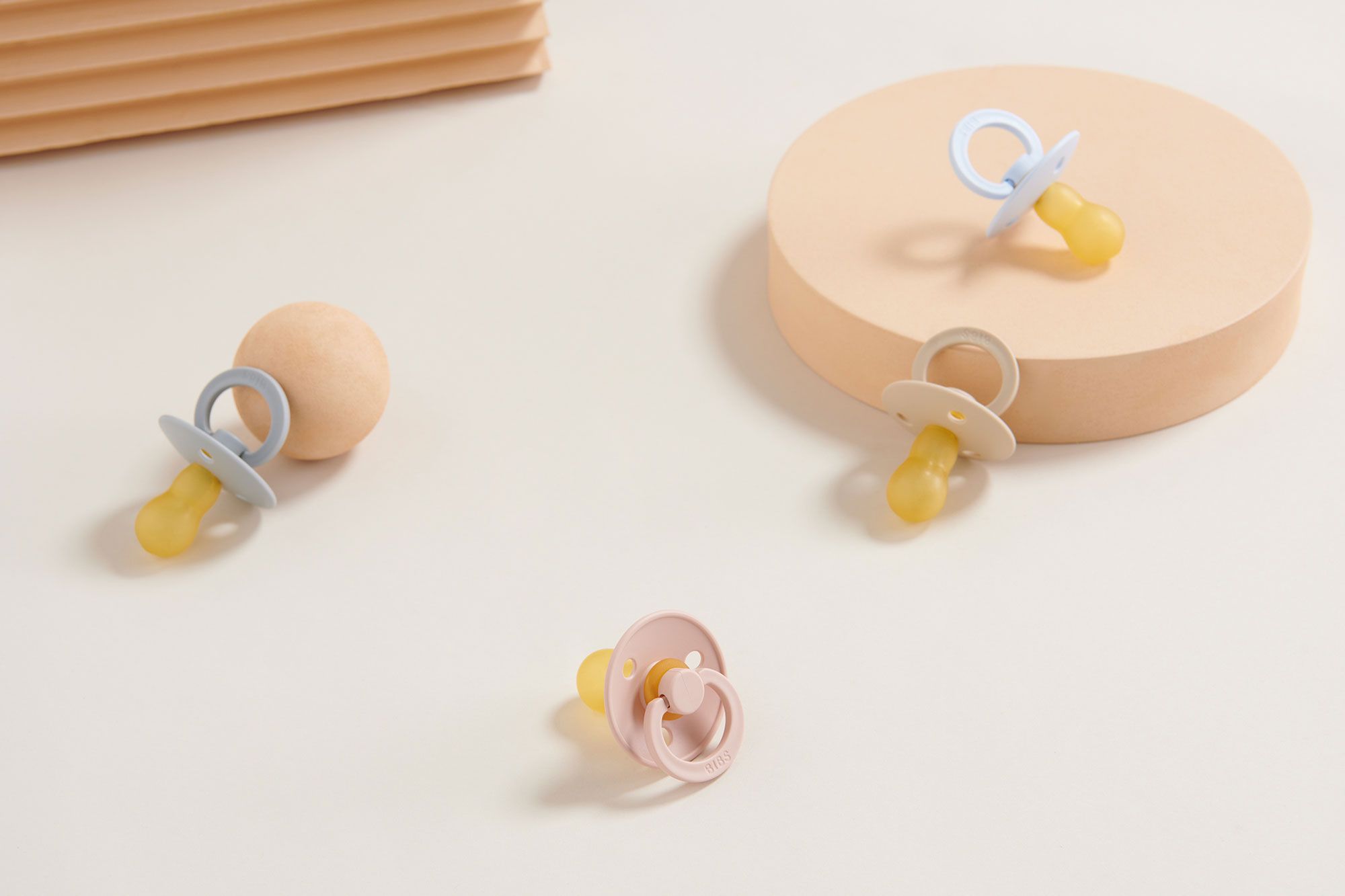 Multicoloured baby dummies sitting on a table