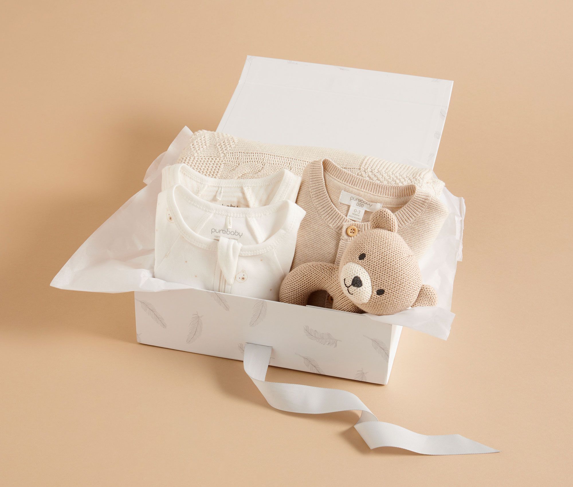 Gift box with neutral unisex baby clothing and blanket