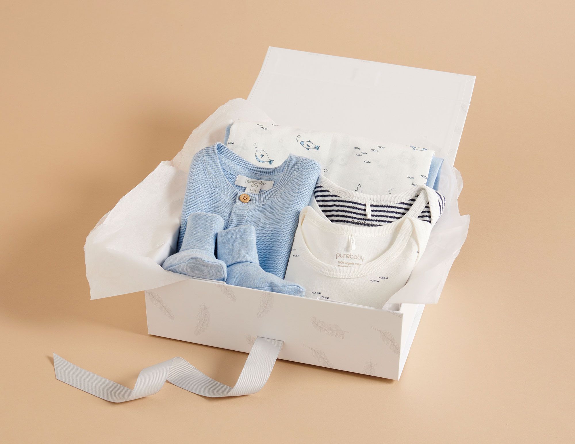 Organic baby gift set including cardigan, bodysuits and booties in blue tones