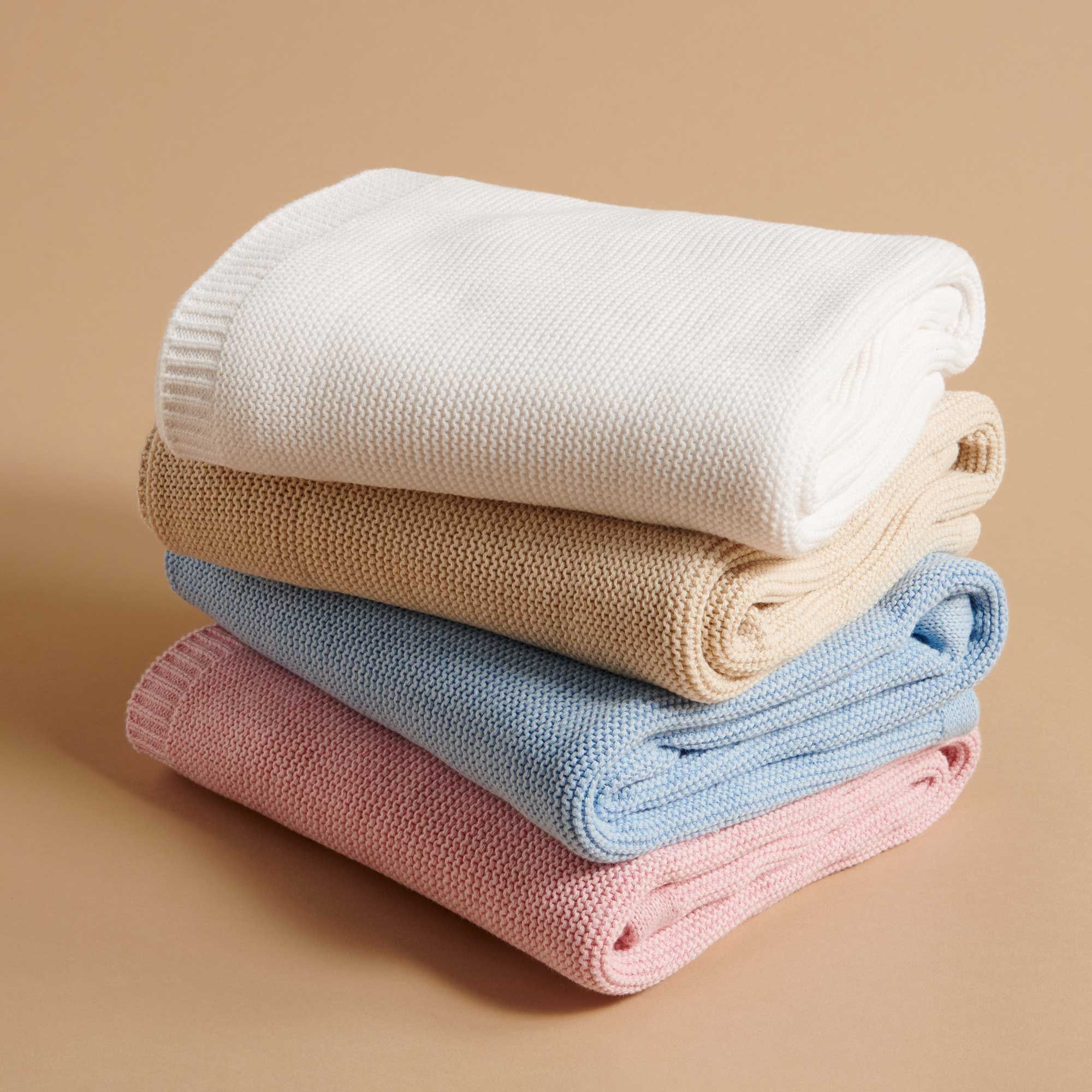 Stack of knitted organic baby blankets