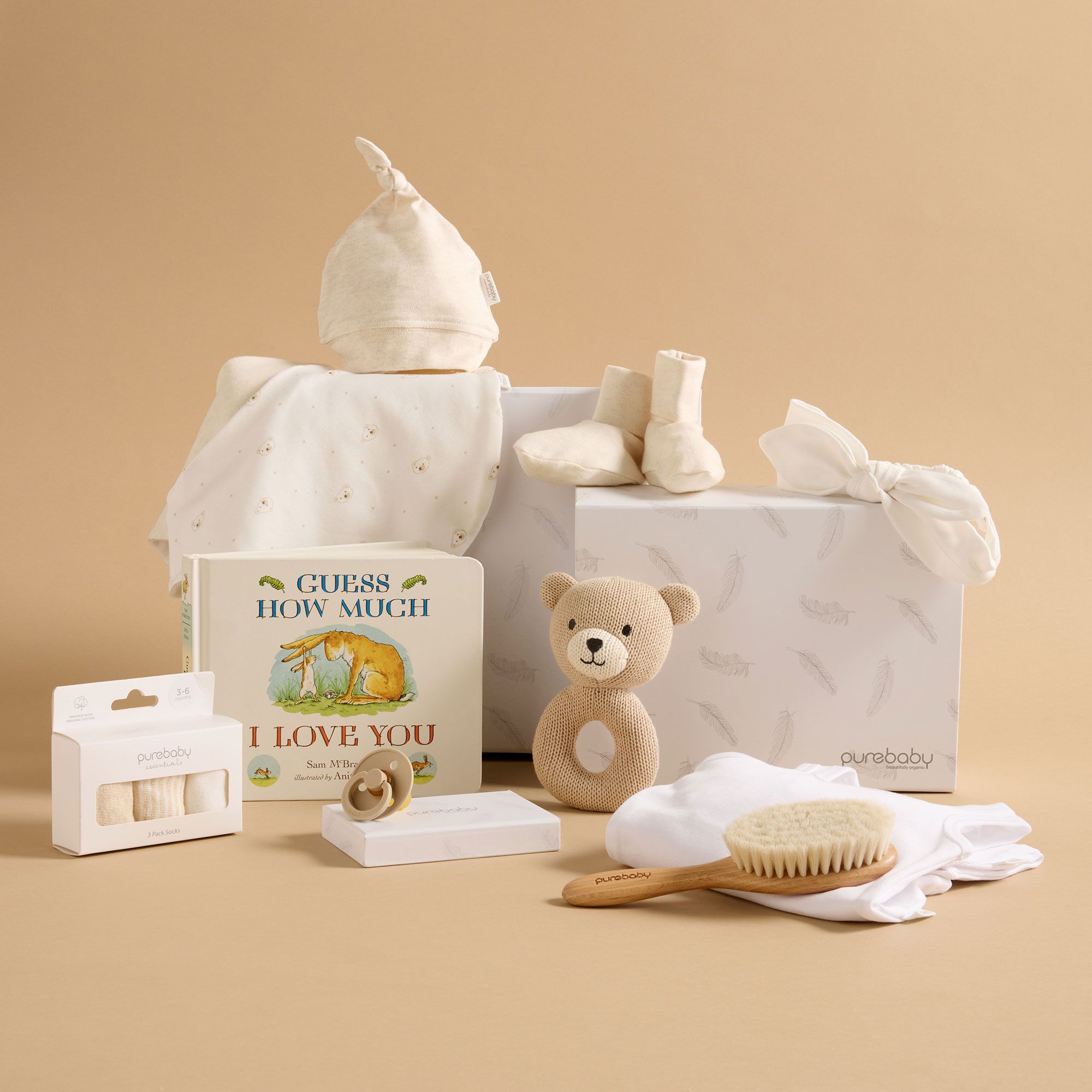 Purebaby baby shower gift ideas including hat, booties, book and brush