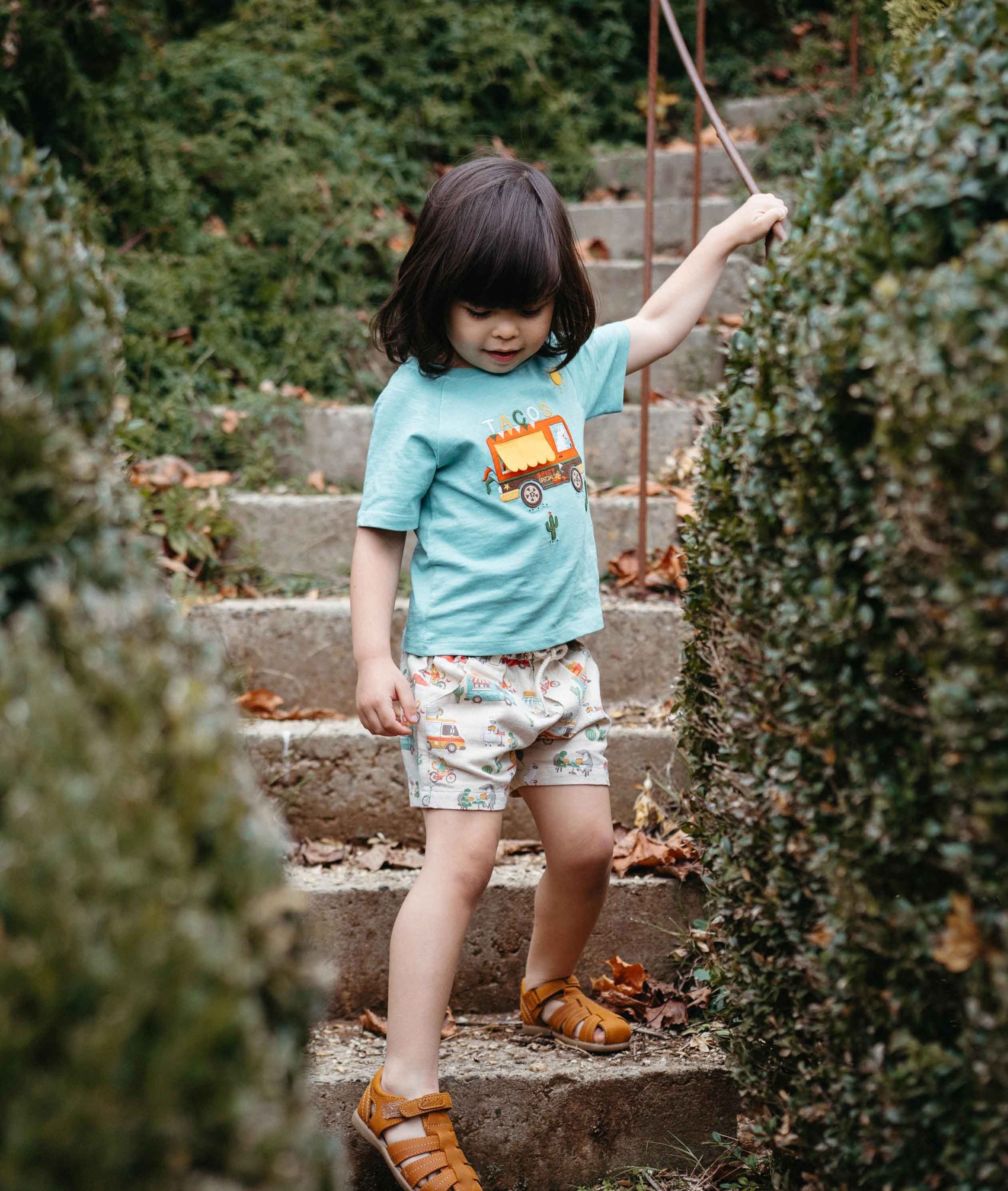 Toddler wearing a lightweight cotton tee and shorts playing outdoors
