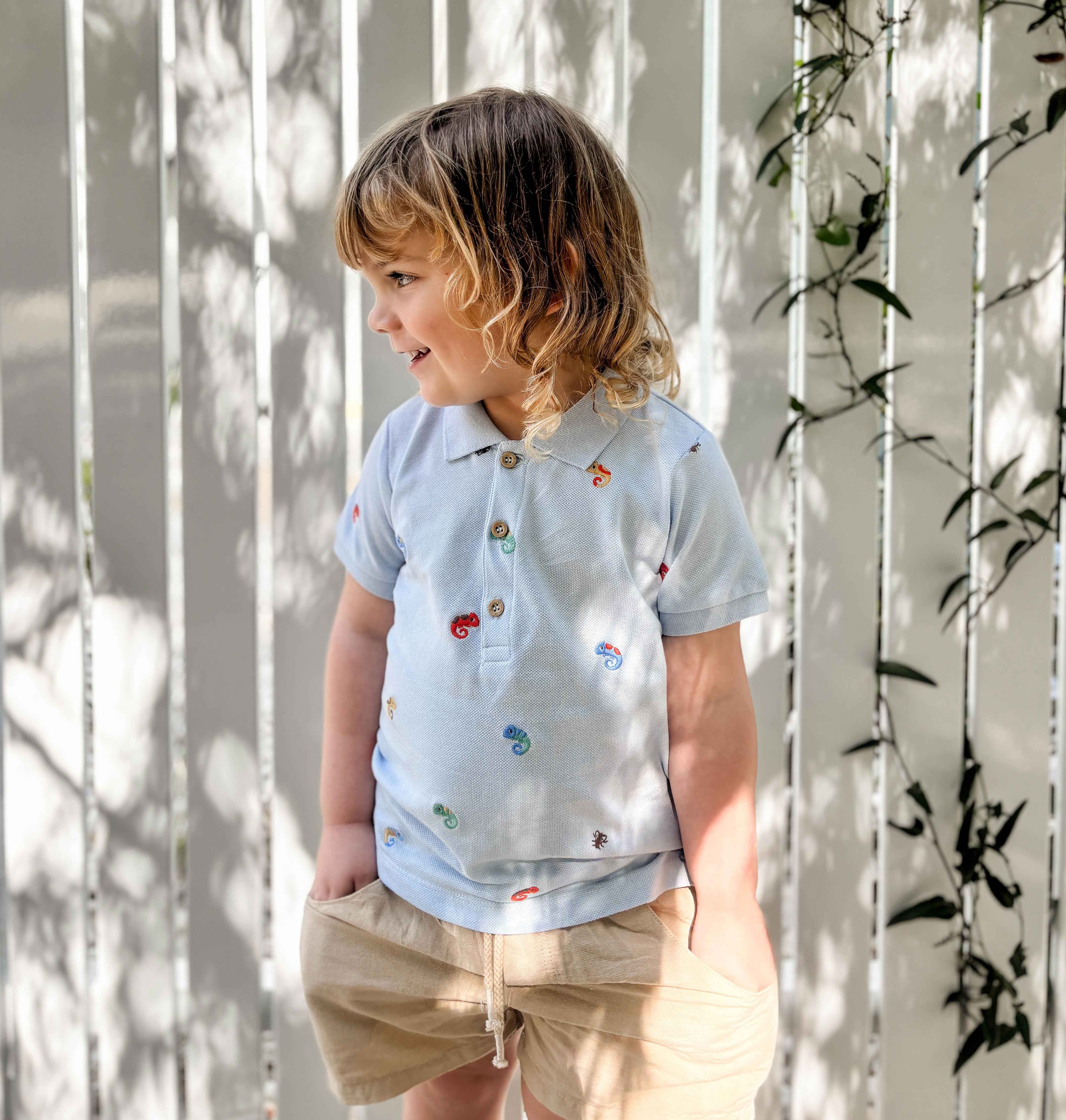 Toddler boy wearing cotton shorts and a polo outside