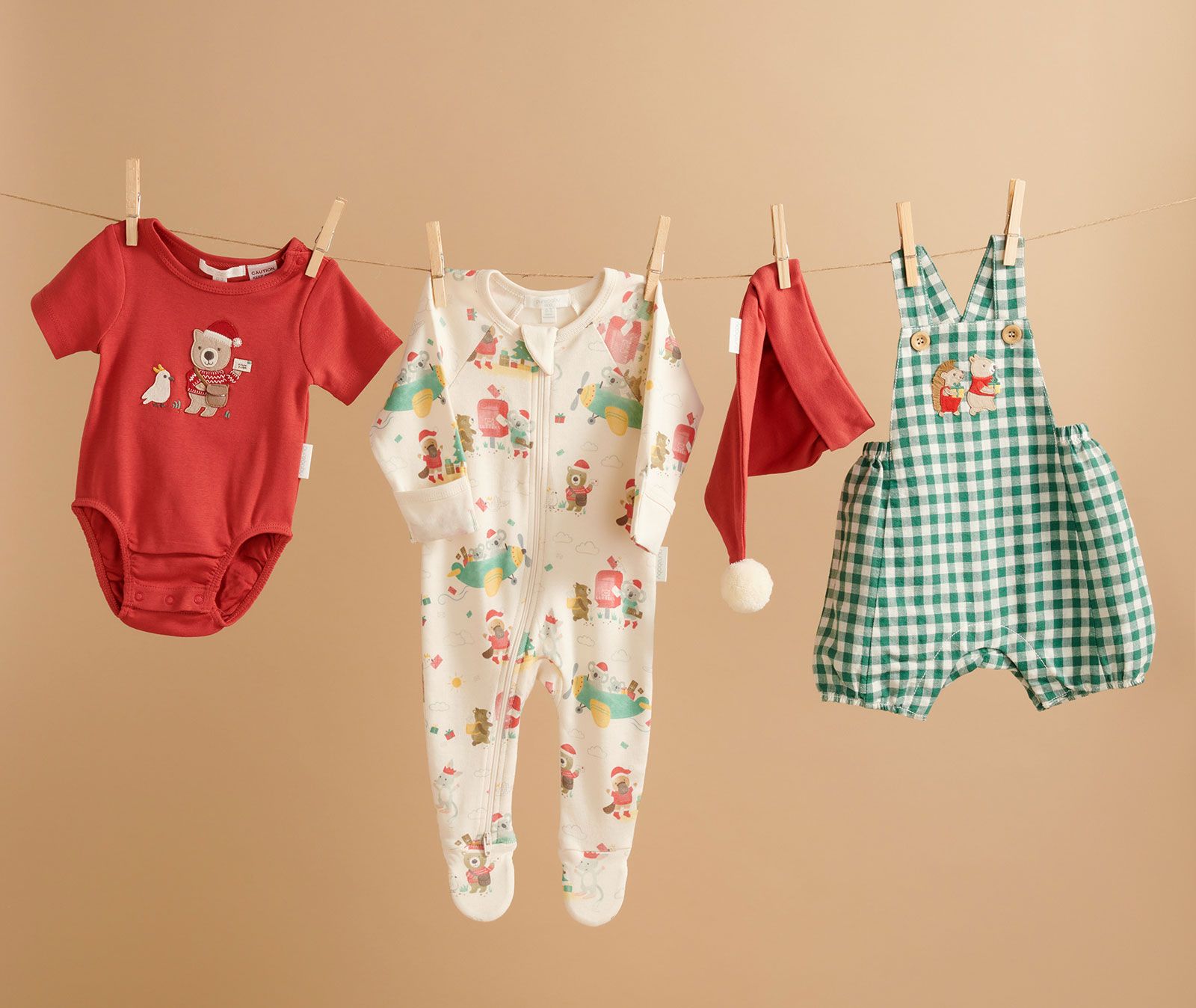Purebaby Christmas clothes hanging on string