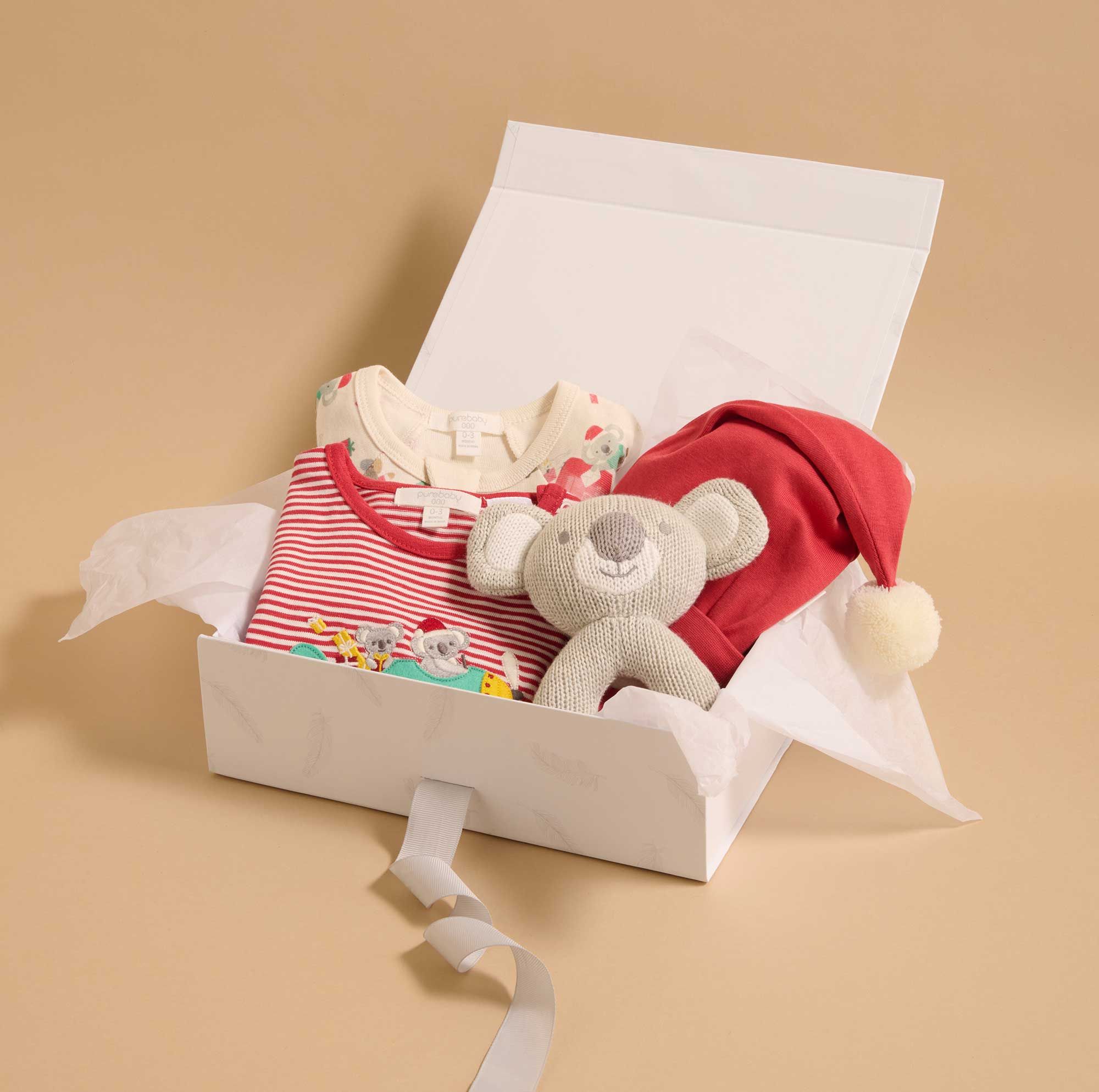 Gift box containing Purebaby baby Christmas styles and rattle