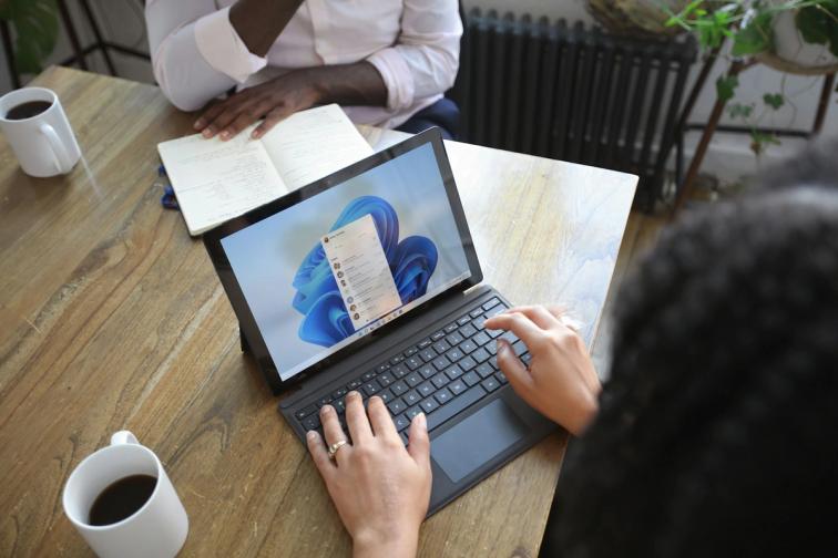 Two people comparing mortgage lender options together at a bright table with a laptop and notebook — lendsimpl guide to monoline lenders in Canada